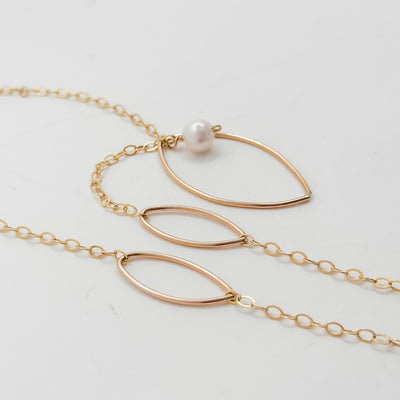 Long leaf lariat with white pearl necklace