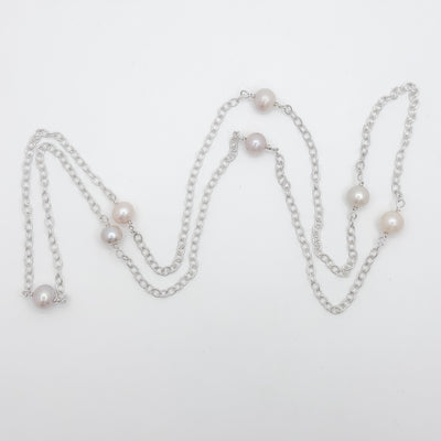 No Yolk with white pearls necklace