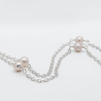 No Yolk with white pearls necklace